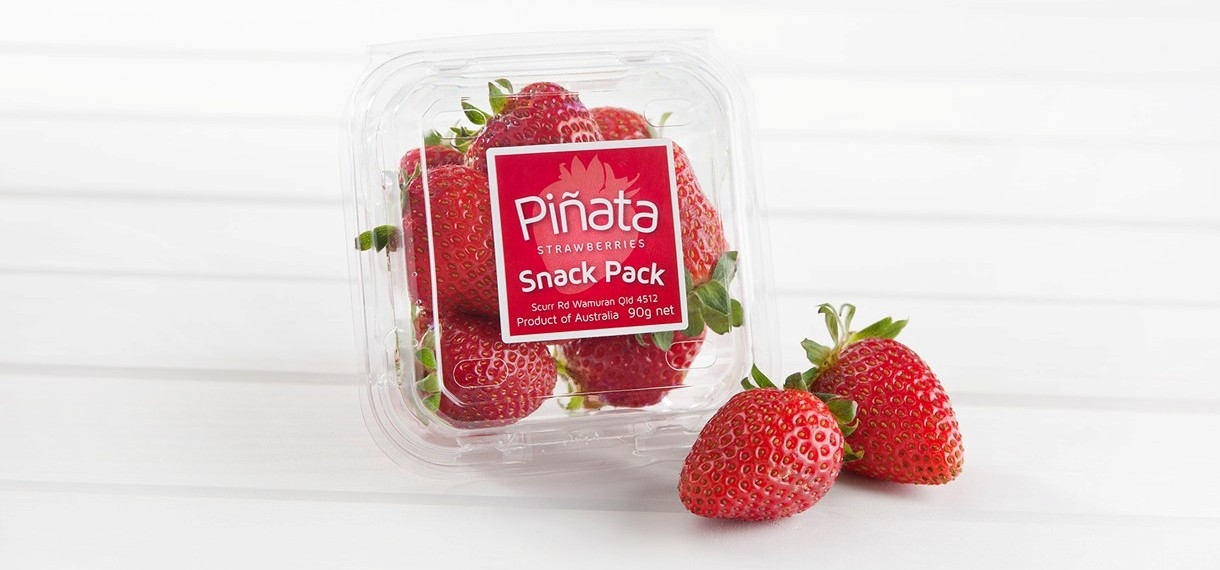 A Pinata strawberry snack pack and fresh strawberries
