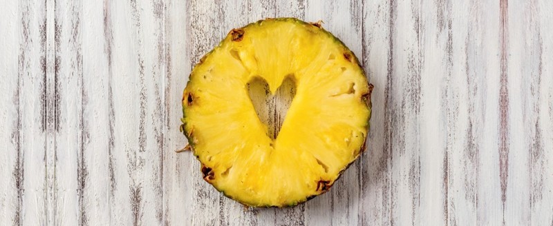 Pineapple with an artistic heart cut into it
